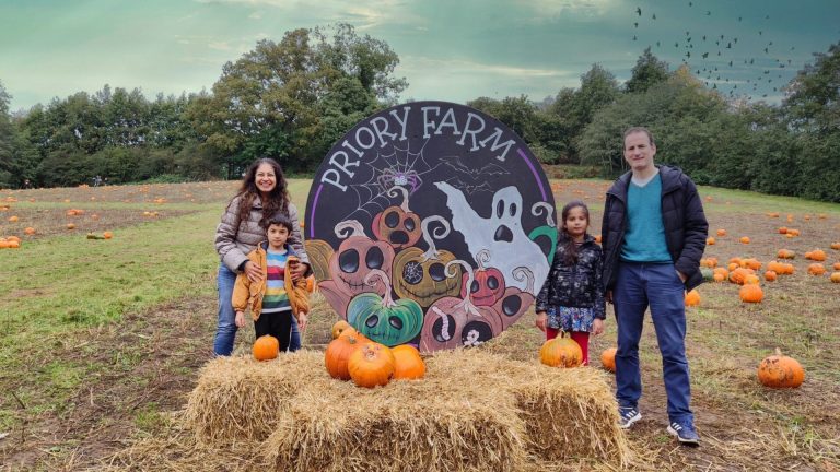 Family pausing for Halloween with ghosts and pumkins