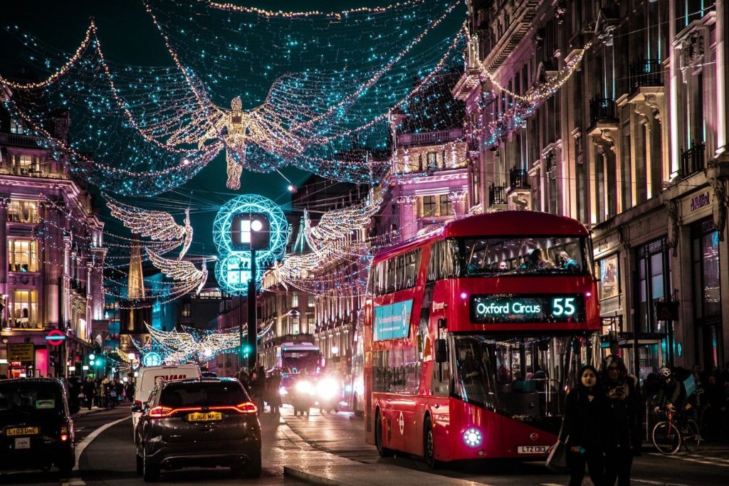 photo of bus passing on city with lights