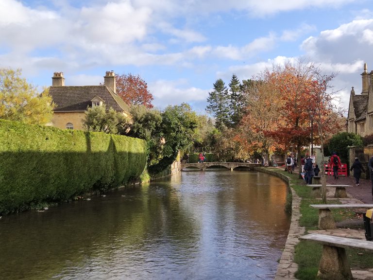 River in the middle of a small town with autumn tree colors