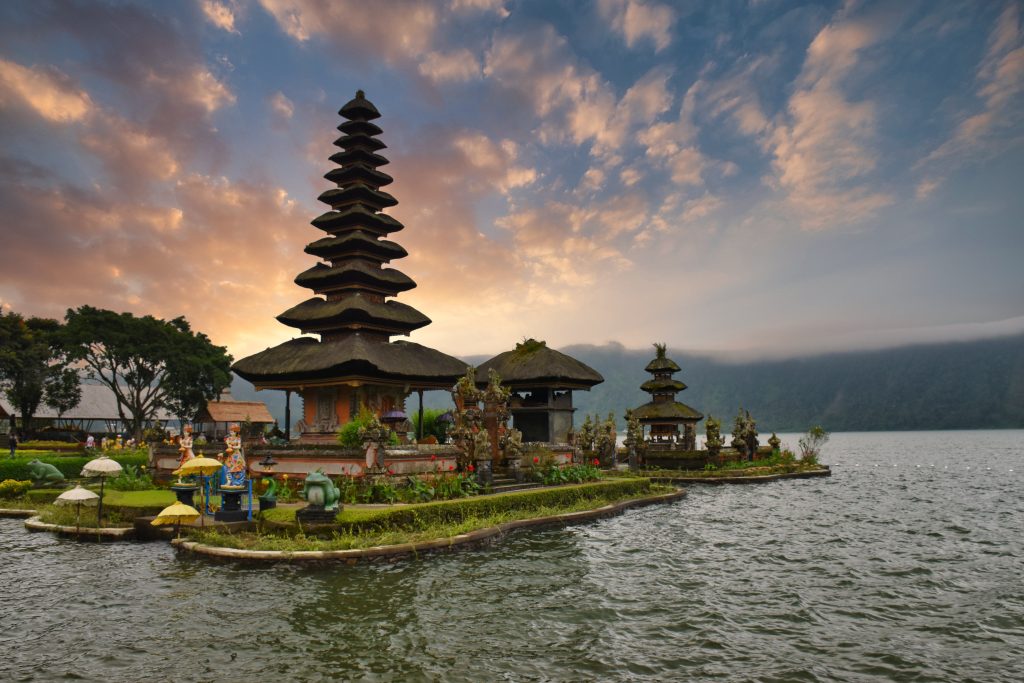 Sunset over a temple by a lake