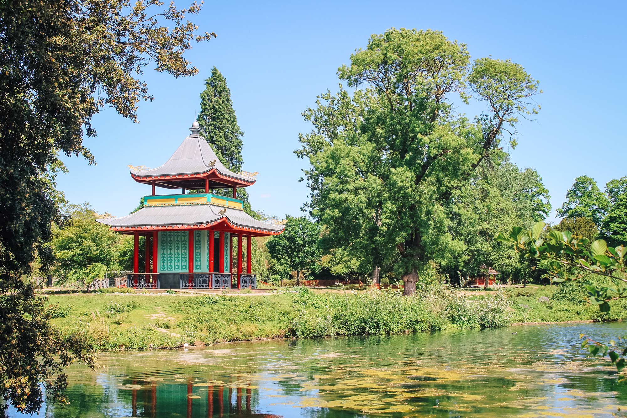 Temple in a flower field near a pond