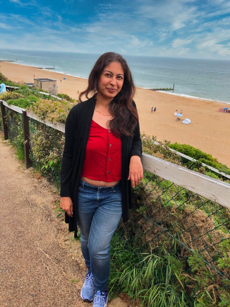 Beautiful woman posing in front of the beach