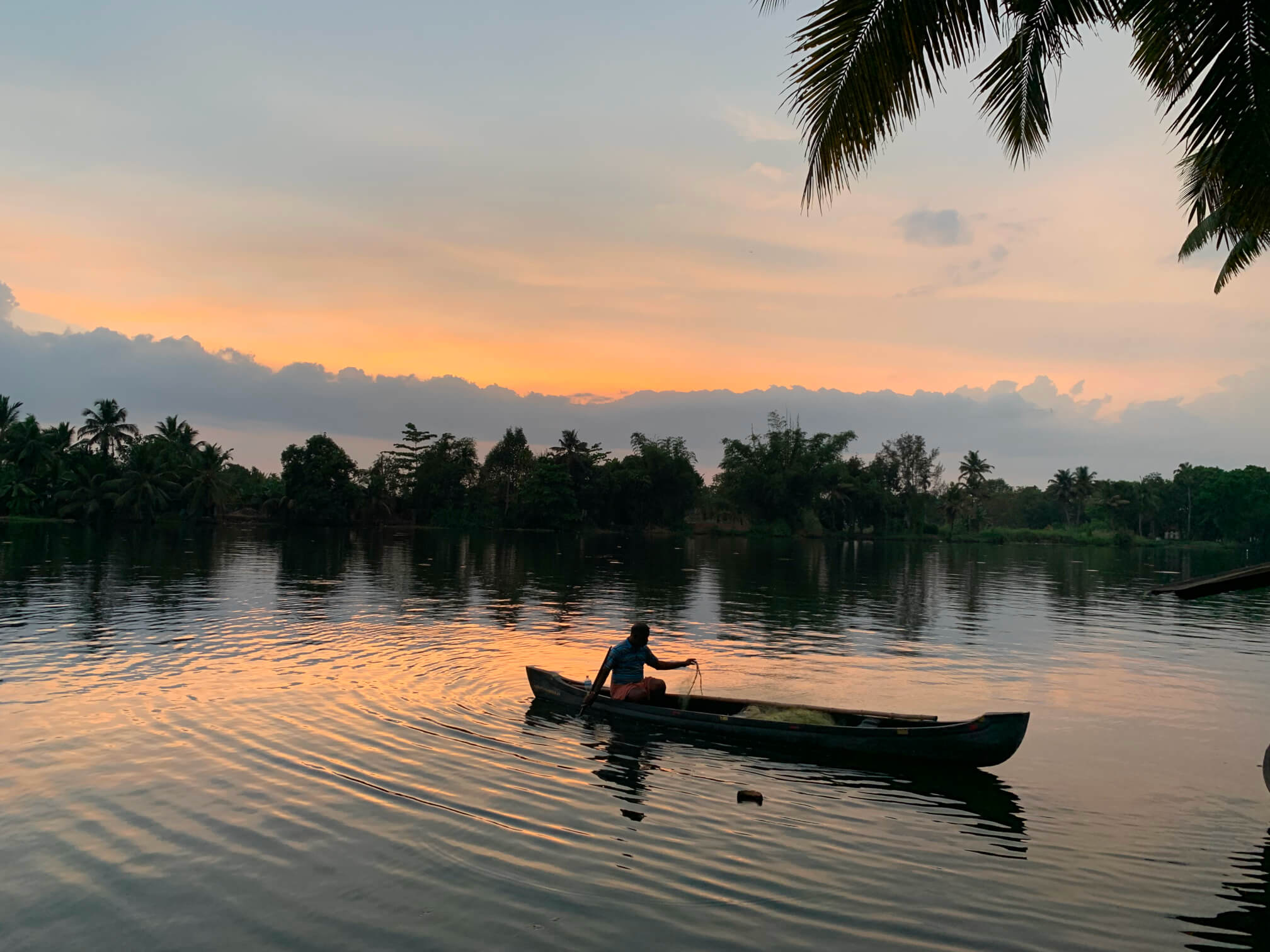 fisher boat on the river at sunset