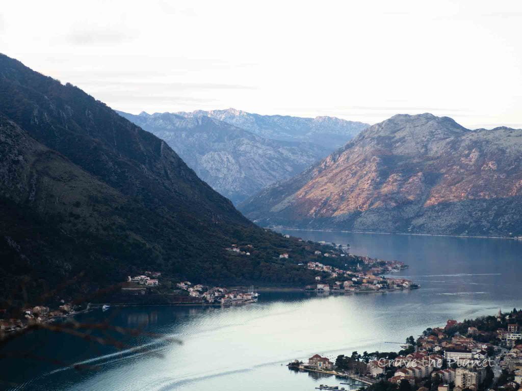 Scenic view of a lac between mountains with a city