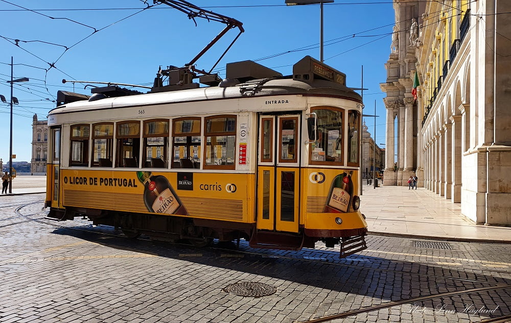 Old style tram in front of a palace