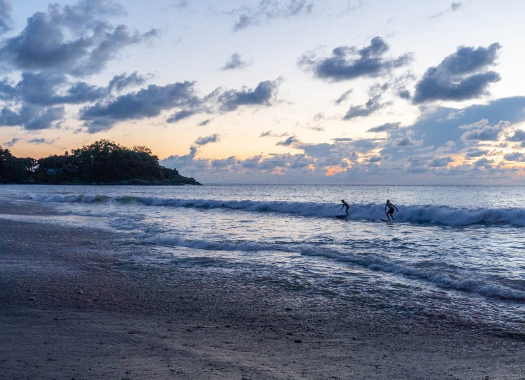 Surfers at sunset