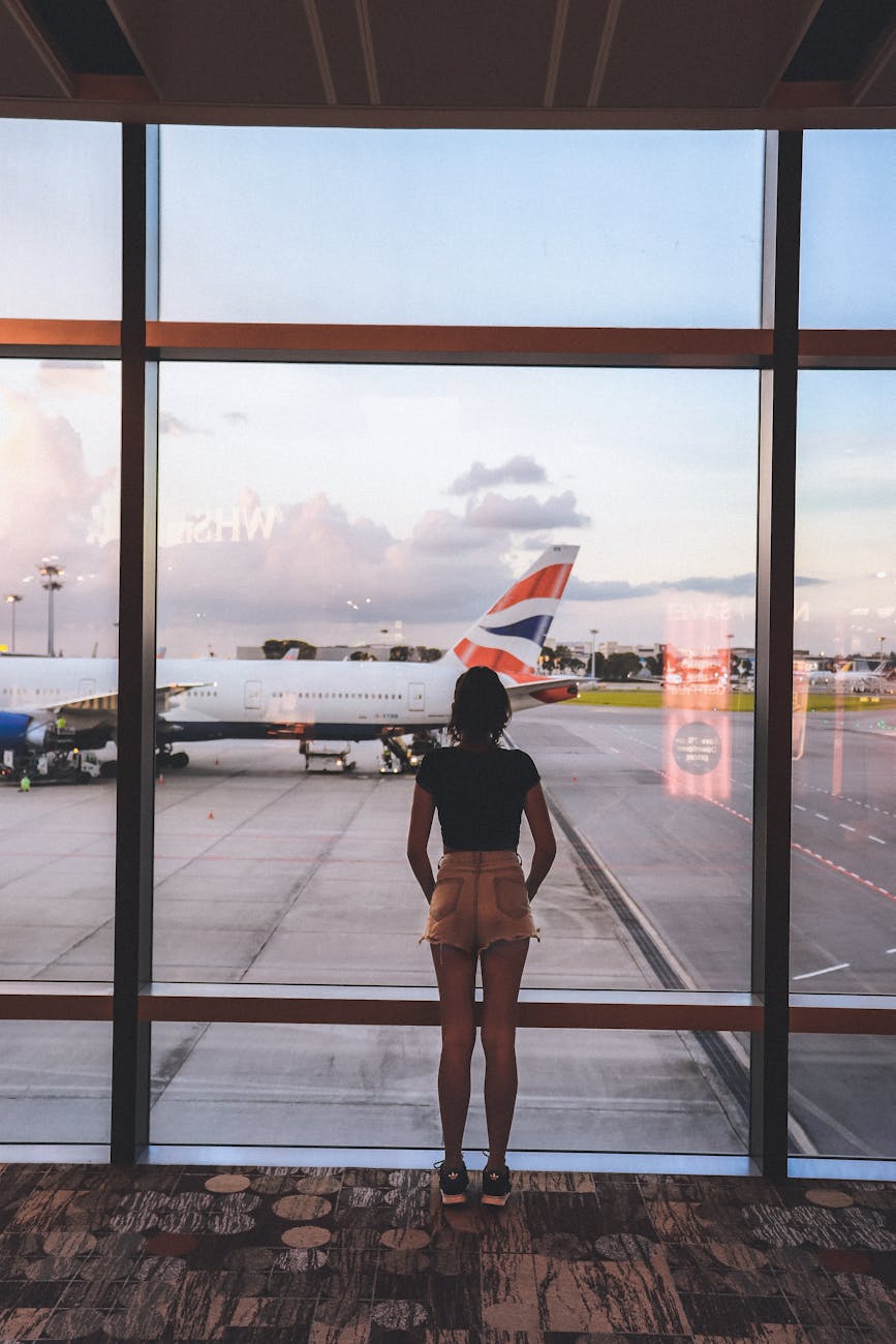 photo of woman standing near glass wall