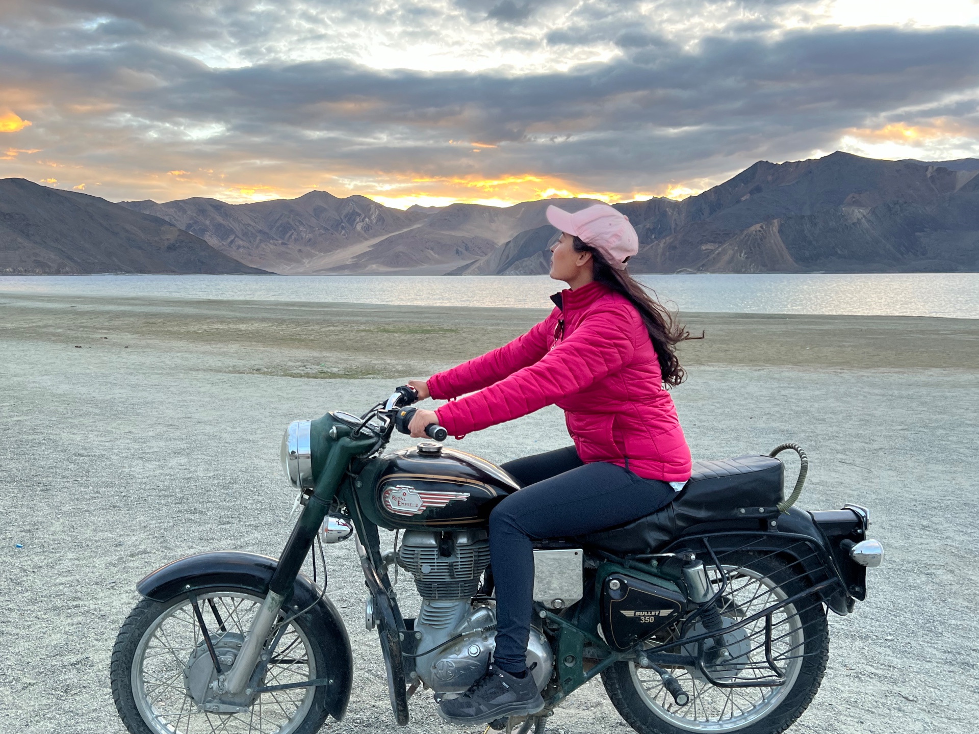 Woman on a motobike in near a lake in the Mountain