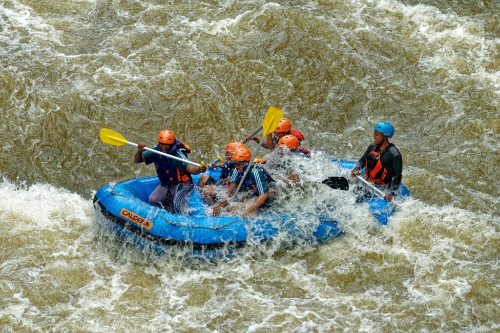 group of men paddling while inside inflatable boat