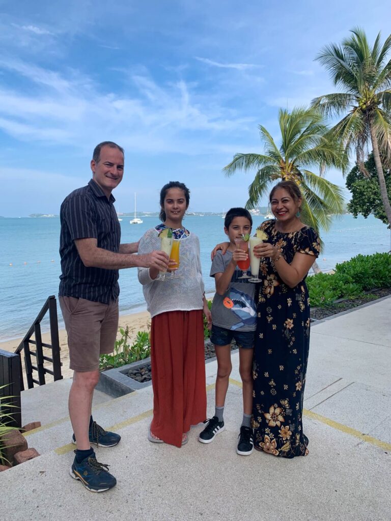 Family having cocktails and mocktails on the beach