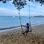 Boy on the Swing on a beach