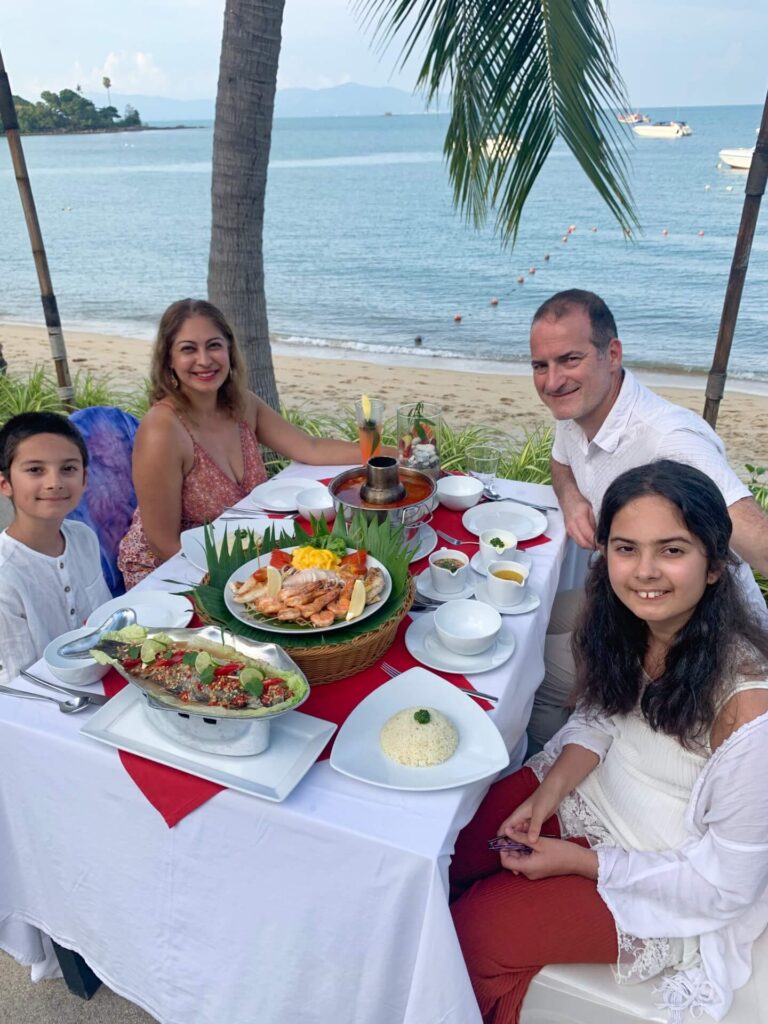 Family having a seafood diner on a beach