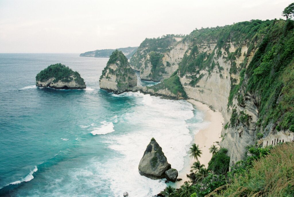 Stunning coastal view showcasing dramatic cliffs and vibrant waves at Nyang Nyang Beach, Bali.